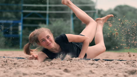 Female-volleyball-player-in-the-fall-hits-the-ball-in-slow-motion-on-the-beach